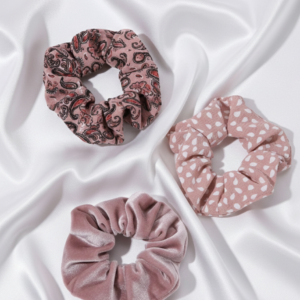 Pink velvet and patterned hair scrunchie set on white silk background