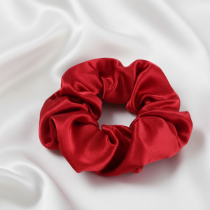 Single large 10cm vibrant red satin silk scrunchie on white silk background
