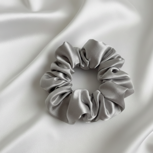 Single large 10cm silver satin silk scrunchie on white silk background