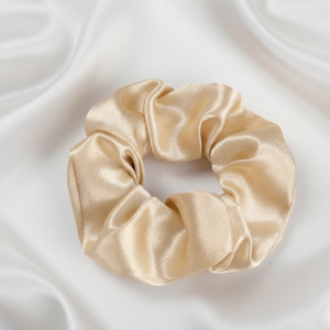 Single large 10cm champagne gold satin silk scrunchie on white silk background