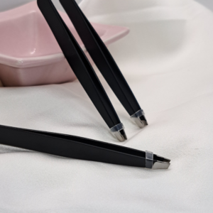 Professional matte black stainless steel slant-tip tweezers on white background
